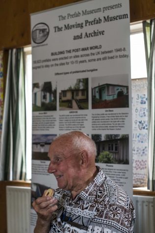 George, prefab resident, eating biscuits at the Moving Prefab event June 2017 | Prefab Museum