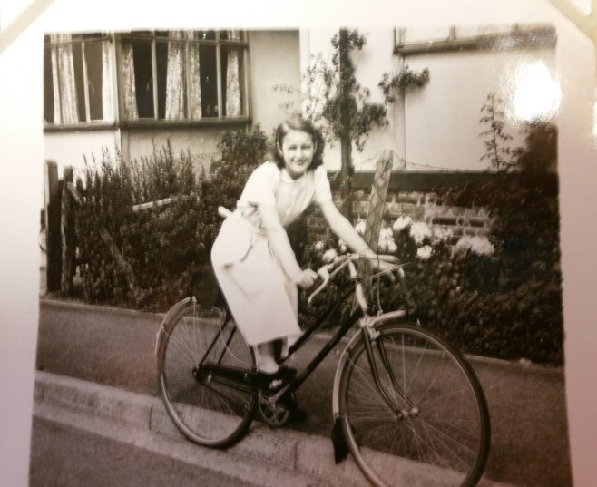 Girl on bicycle in front of prefab | Hearn,Jane