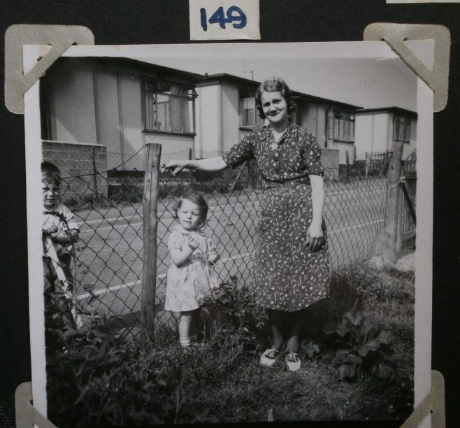 Mrs Prosser with two small children in prefab garden | Hearn,Jane