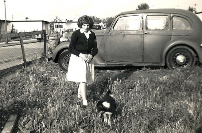 Woman, possibly of the Brine family in a prefab garden with car | Blanchet,Elisabeth