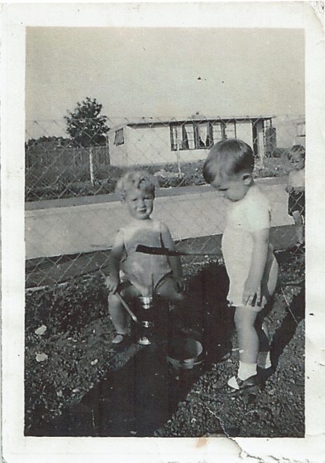 Two small children playing with buckets and spades in the prefab garden, Clement Road | Christine and Peter Bedell