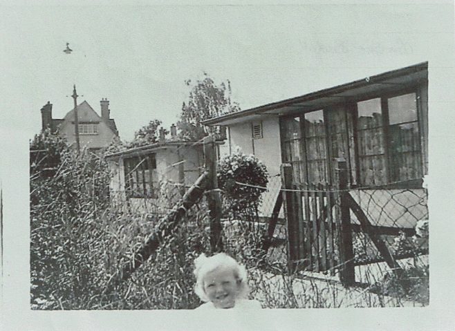 Small child in prefab garden in Willesden | Hearn, Jane