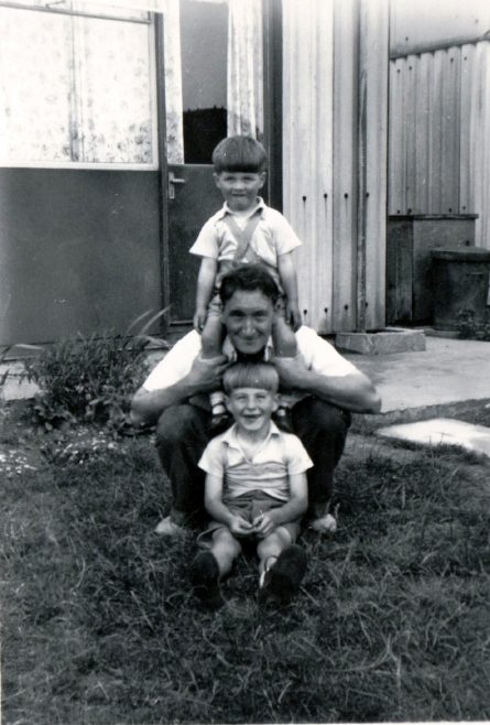 Man with two small boys in prefab garden. Kedleston Gardens, Hainault