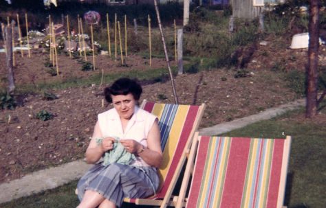 Elsie knitting in the prefab garden. Sixth Street, Pollards Hill